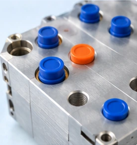Silicone plugs protecting precision machined ports